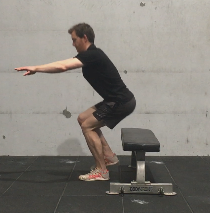 strong runner doing sit to stand exercises