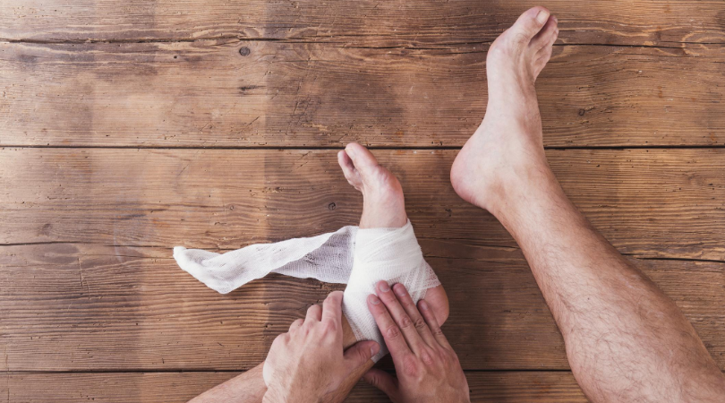 injured runner with foot bandaged