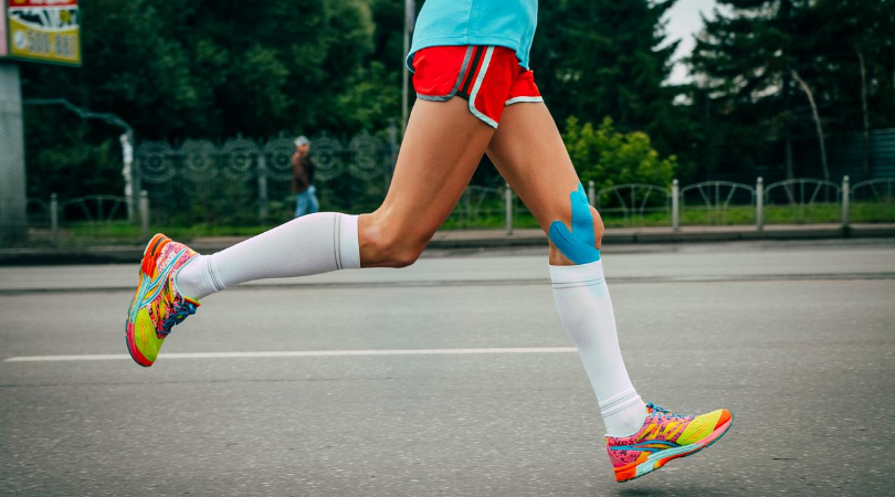 runner running with tape on knee