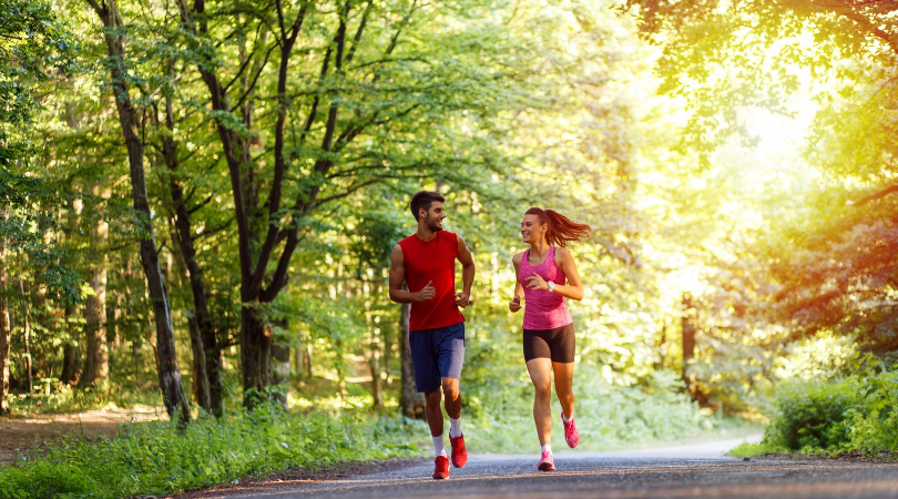 two friends running in park