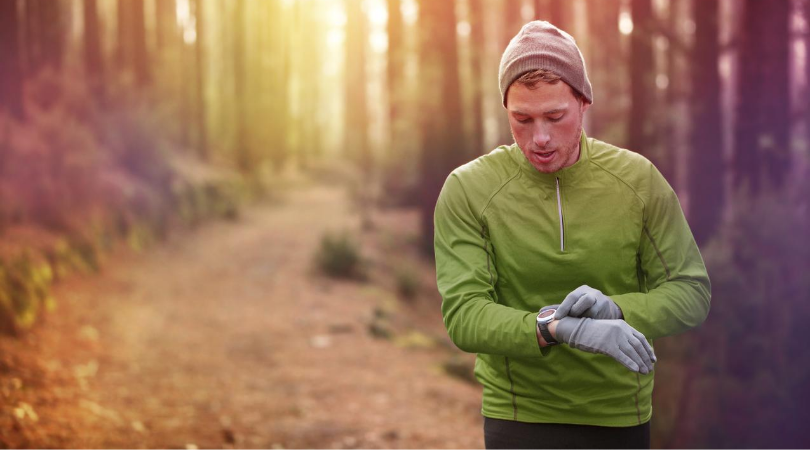 Runner with wearable technology in the forest