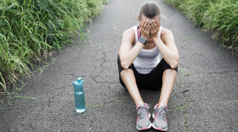 frustrated running sitting on the road