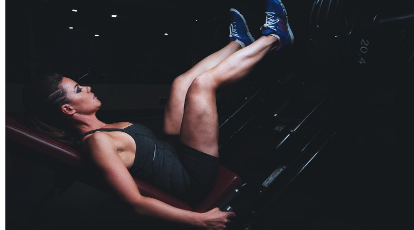 Runner in the gym doing leg press