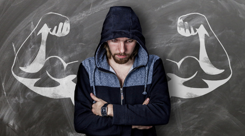 runner looking depressed with powerful arms painting on the wall behind him