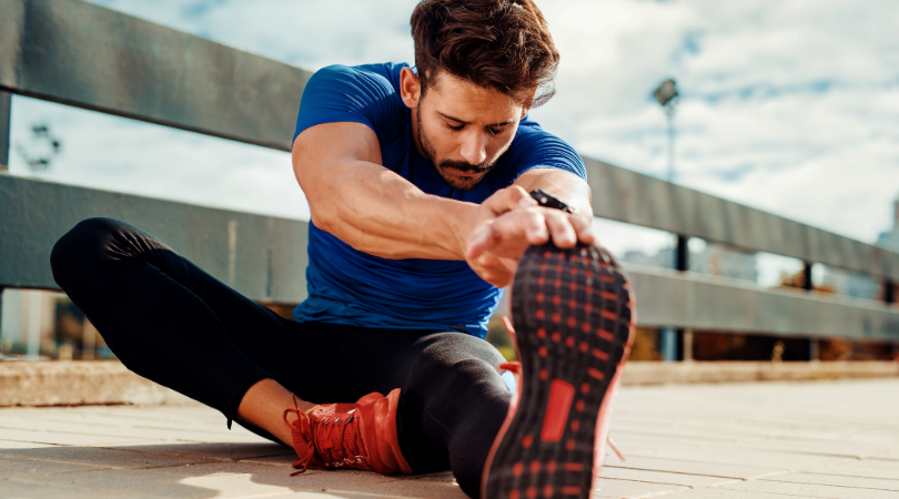 runner stretching hamstrings before a run