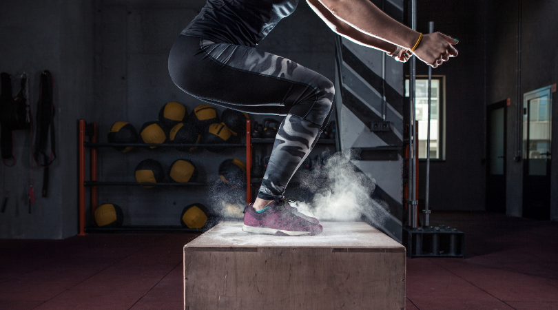 runner doing box jumps in the gym